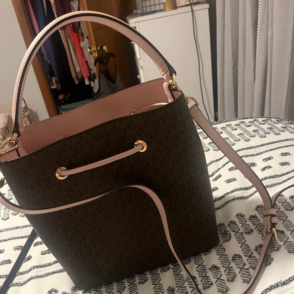 Brown and pink Michael Kors bucket purse.